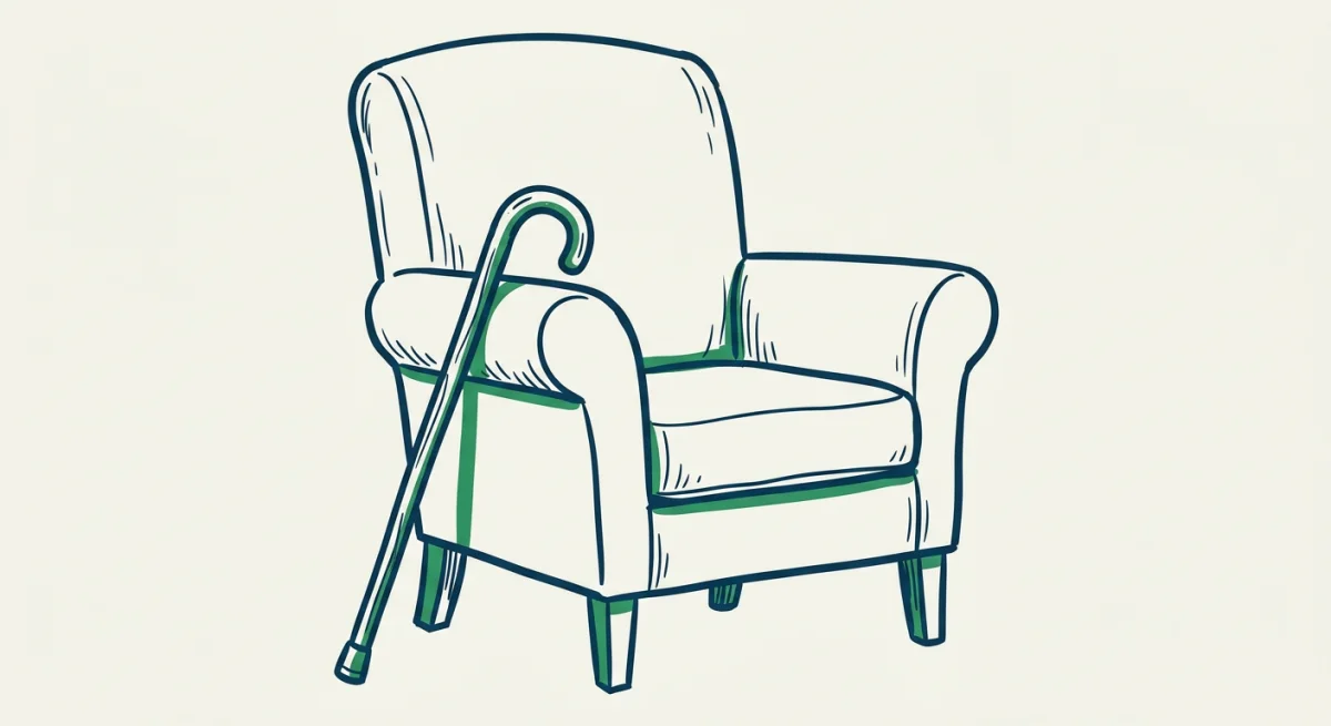 a walking stick leaning against a simple armchair